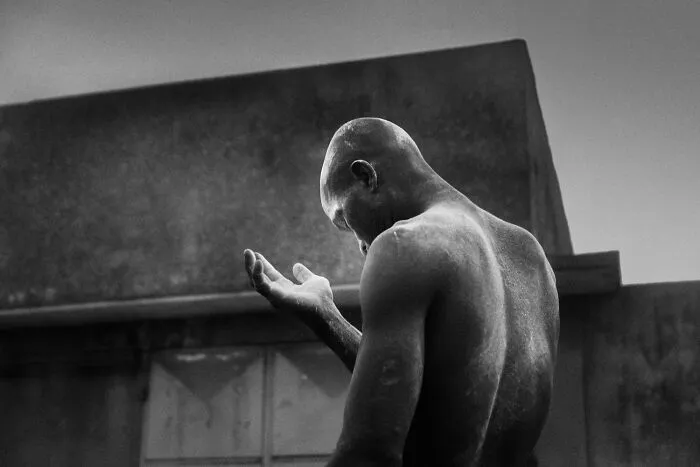 Emotive black and white analog film photo of a contemplative man