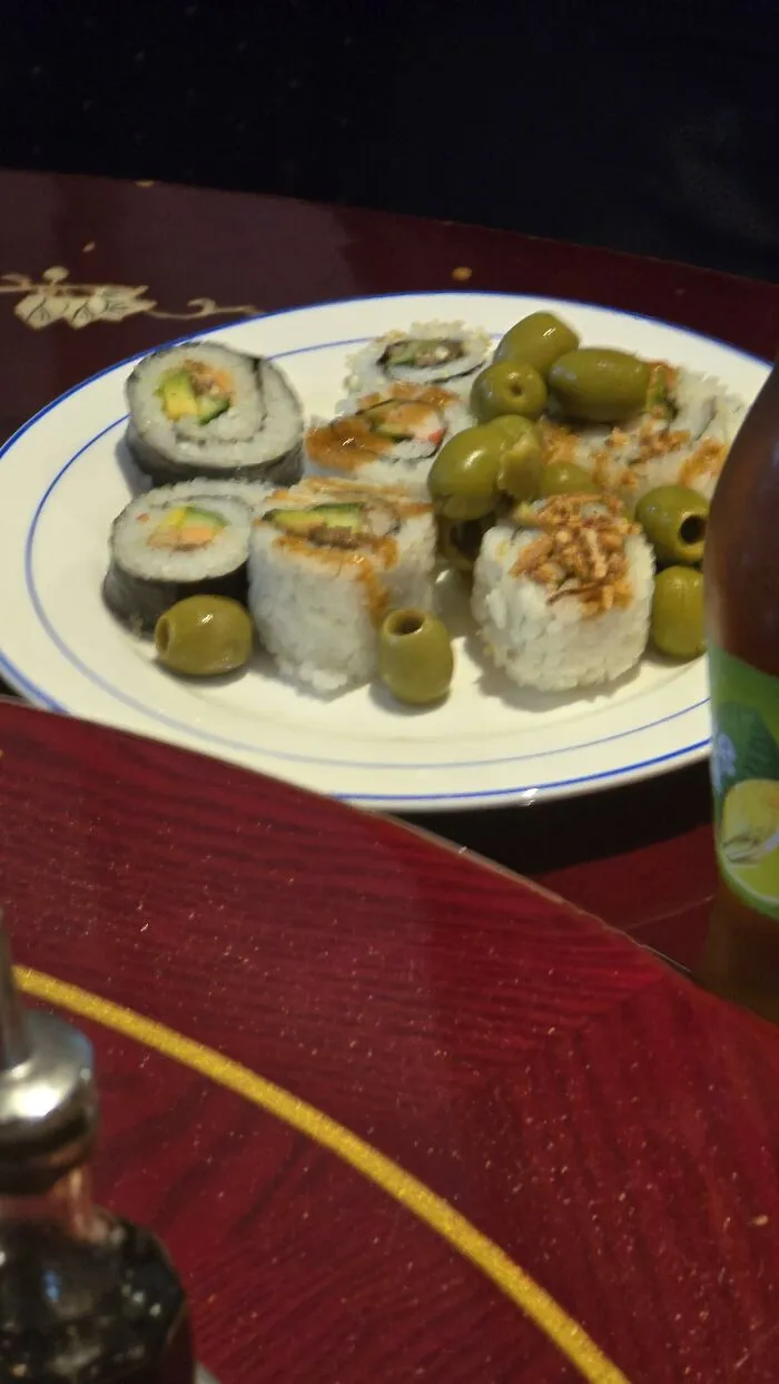 Weird food combinations showing sushi rolls garnished with green olives