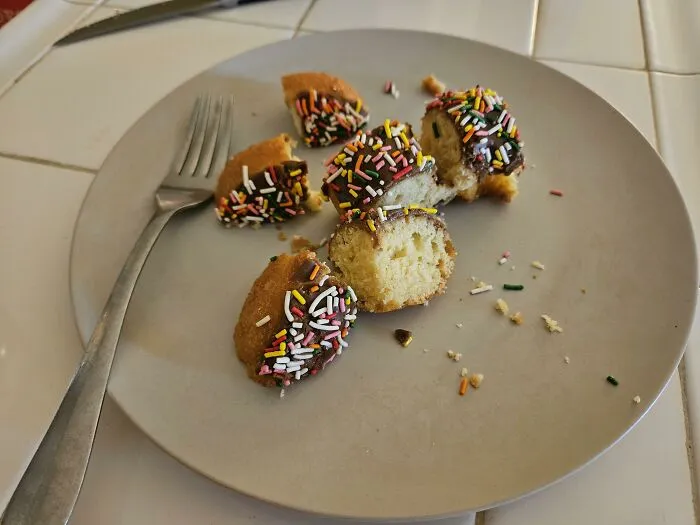 Pieces of cake with sprinkles on a plate, showcasing unusual food combinations.