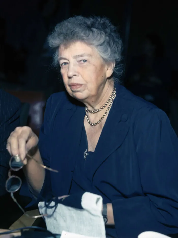 An older female teacher holding her glasses, showing how teachers recall the students from the past