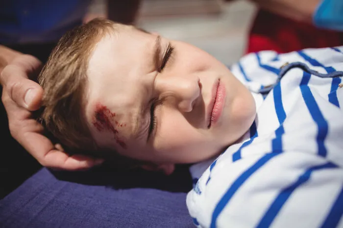 A young boy with a head injury, recalling a moment when a student lacked common sense in class