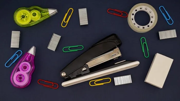 Various school supplies spread on a desk, representing the tools of students in class