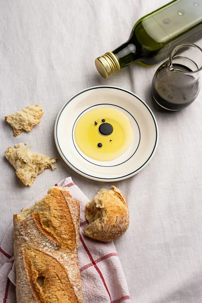 Crusty bread with olive oil and balsamic vinegar, illustrating a middle-class life luxury.