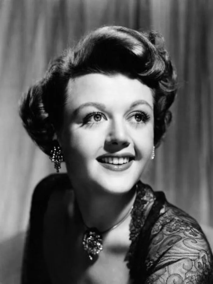 Classic black and white portrait of actress Angela Lansbury smiling, illustrating new facts about her life