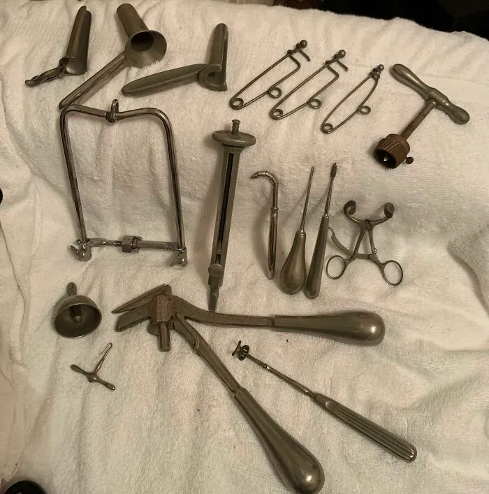 A collection of old, metallic surgical tools showing how much medicine has changed over time.