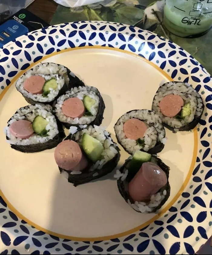 Sushi rolls stuffed with hot dog pieces and cucumber, showing weird food combinations