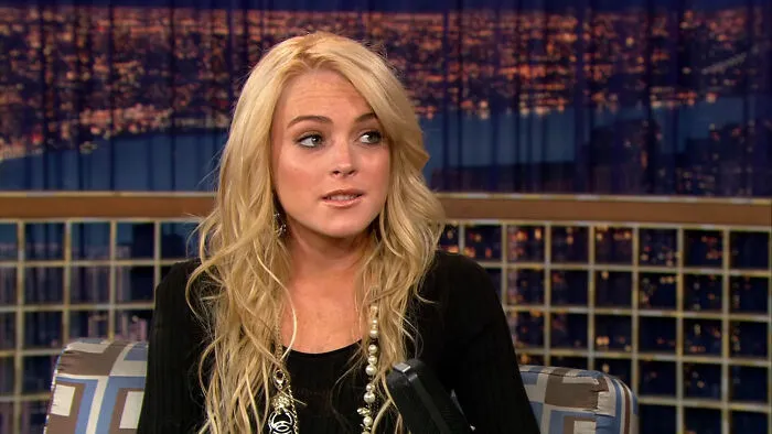 Lindsay Lohan during a talk show appearance talking about celebrity encounters.