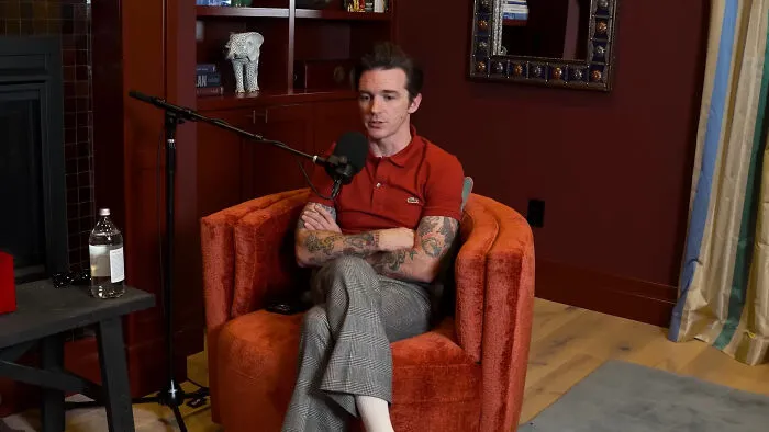 Drake Bell seated for an interview, representing memorable celebrity encounters.