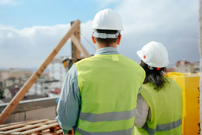 Construction workers looking at a site, reflecting how the economy is in trouble.