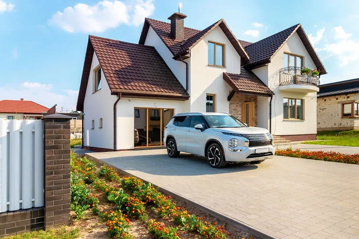 A white SUV parked in front of a modern house, a lifestyle element tied to marriage regrets