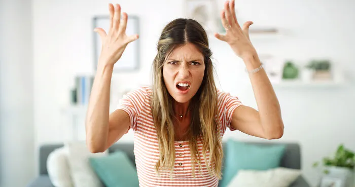 An angry woman gesturing with hands, reflecting common marriage regrets