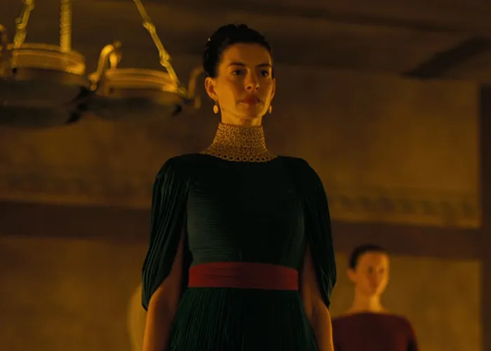 Anne Hathaway in a dark green dress, representing a discussion on Hollywood's plastic surgery obsession