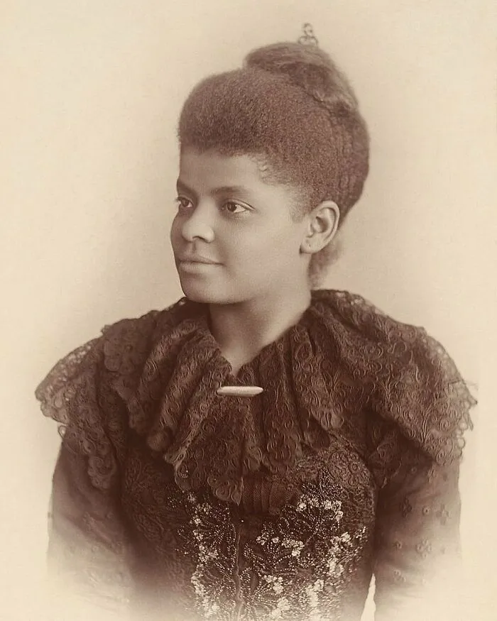 Sepia-toned portrait of Ida B. Wells, a powerful woman in history, wearing an ornate lace dress.