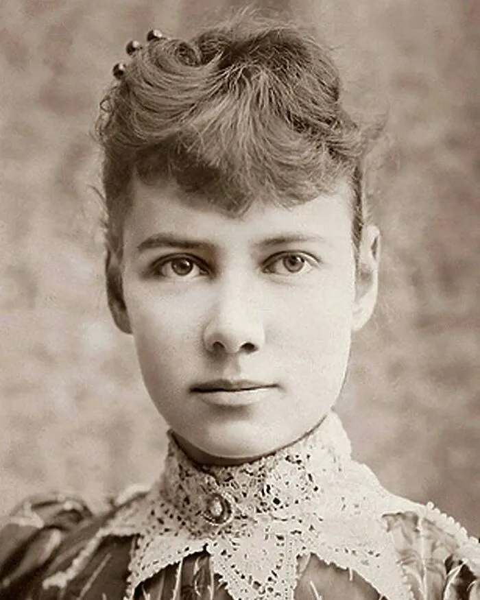 Sepia-toned portrait of a young woman with a high-collared lace dress, showcasing women in history.