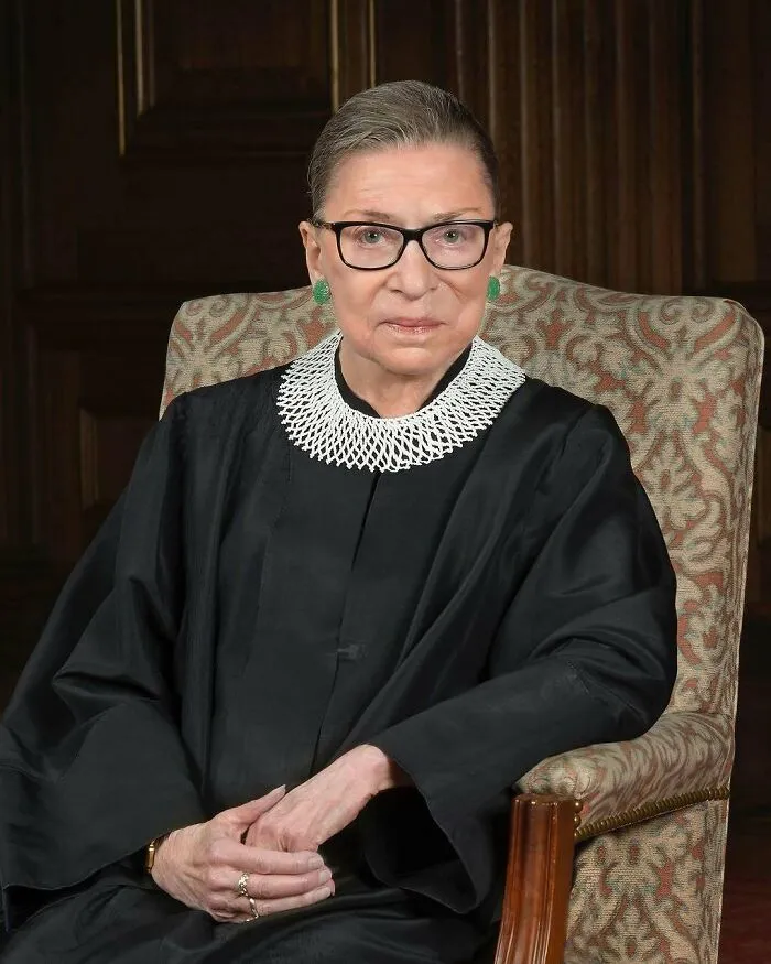 A portrait of Ruth Bader Ginsburg in her judicial robes, a significant figure among women in history.
