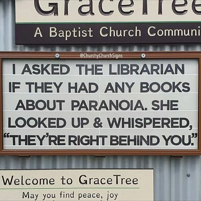 Hilarious church sign about paranoia books being right behind you at GraceTree Baptist church