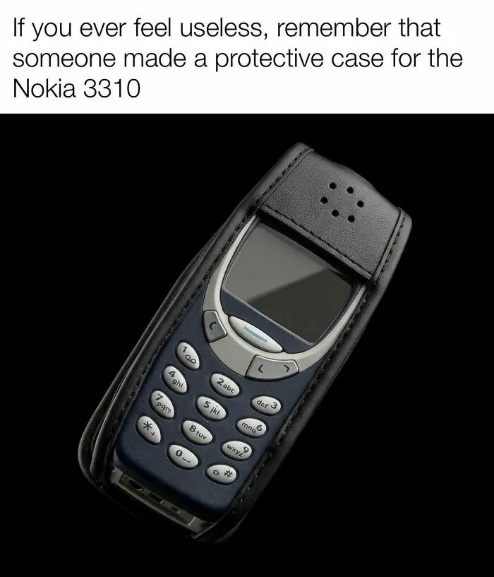 A Nokia 3310 phone in a protective case reflects nostalgic childhood 90s memes.