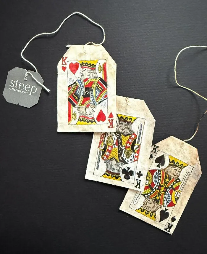 King playing cards depicted in delicate miniature paintings on used tea bags