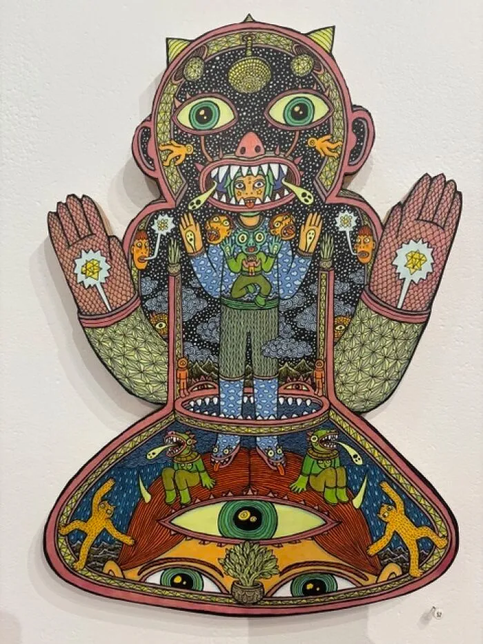 Intricate Theo Ellsworth figure with eyes, creatures, and cosmic patterns in a bold cutout design