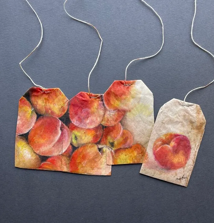 Artist Ruby Silvious miniature paintings of fresh red peaches on four tea bags