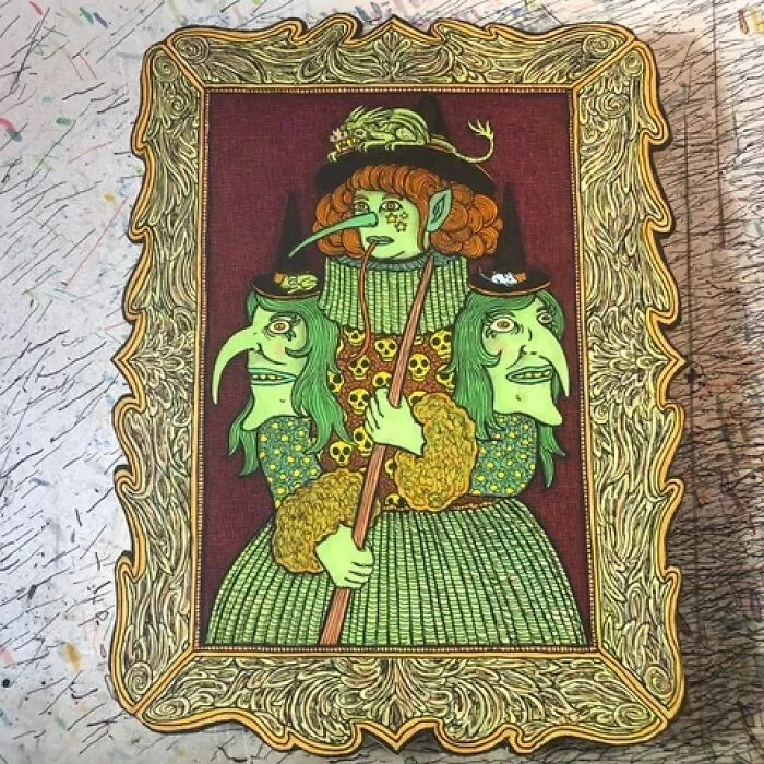 Theo Ellsworth art with green three-faced figure in ornate frame