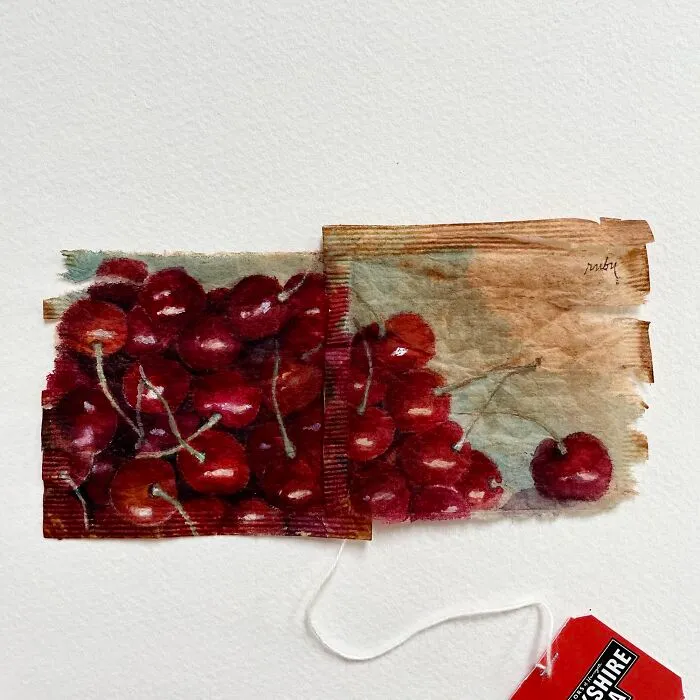 A cluster of ripe red cherries illustrated in miniature paintings on tea bags