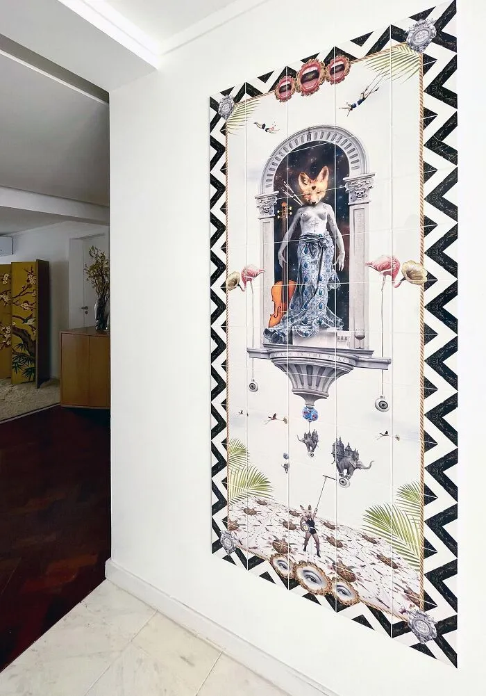 Hallway wall tile works depicting fox-headed figure and black-and-white zigzag border