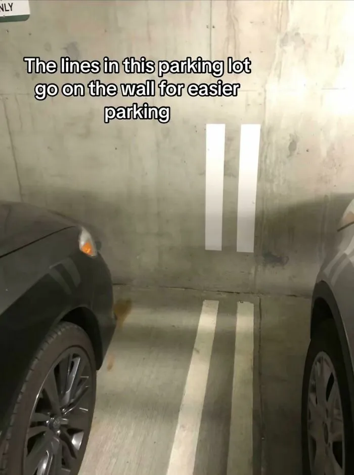 Parking lot with lines extending onto wall for easier parking clever design