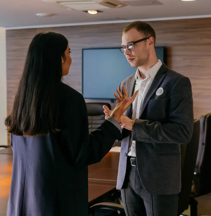 Two professionals debating ideas about clever insults in office