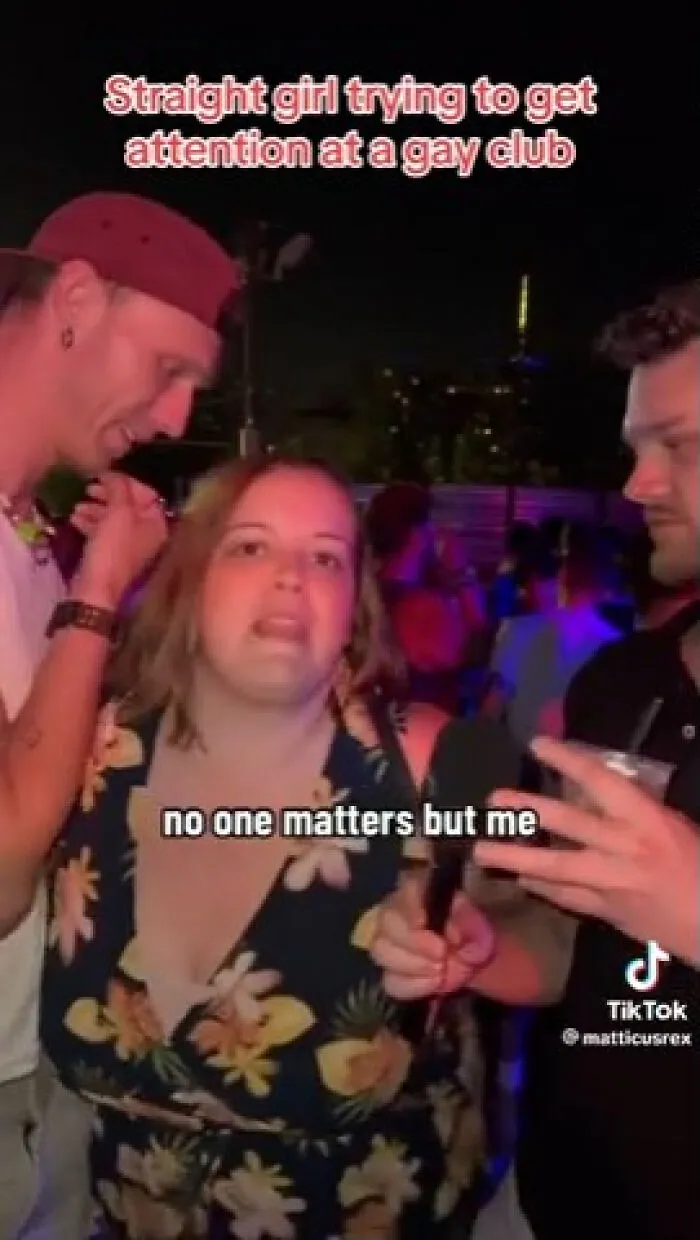 A girl trying to get attention at a club, showcasing a main character attitude among other guests.