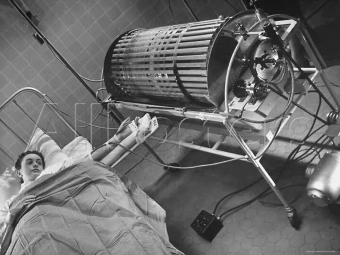 An early dialysis machine beside a patient, showing how much medicine has changed over time