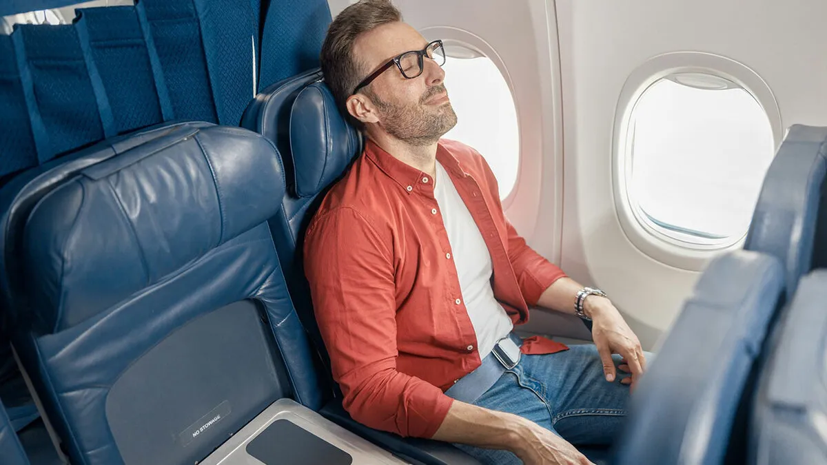 Man Kicks Woman Under Her Seat, Suddenly Changes His Tune When Her Son Steps In