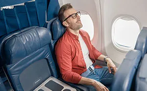 Man Kicks Woman Under Her Seat, Suddenly Changes His Tune When Her Son Steps In