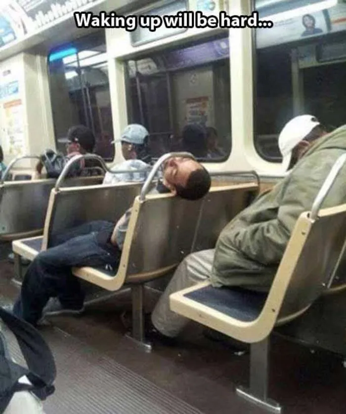 A passenger sleeping on public transport with his head awkwardly stuck through the seat frame
