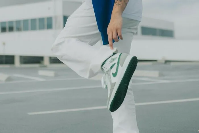 Person displaying green sneakers, dealing with a plane seatmate from hell