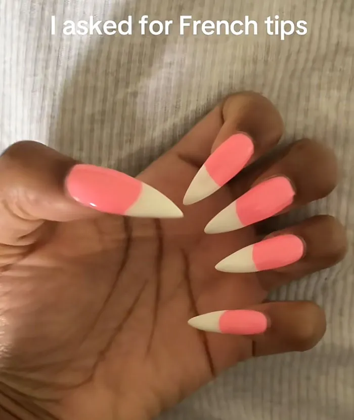 Extremely long pointed pink and white nails showing bad manicures as beauty procedures fails.