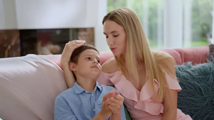 A mother comforting her young son, reflecting on how divorced people talk about family changes
