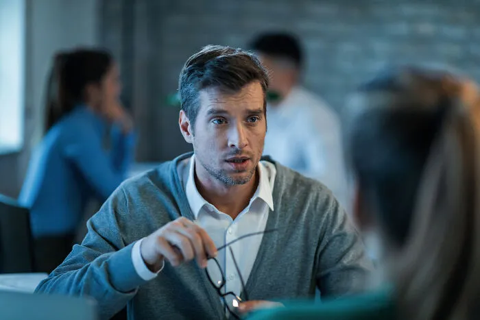 Man explaining something seriously in office discussion