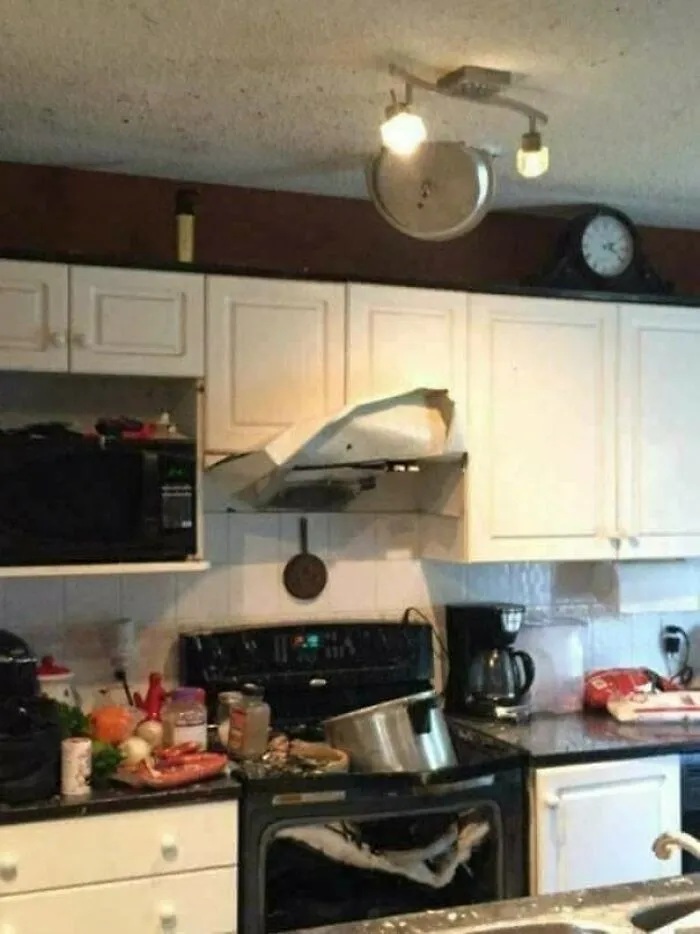 Kitchen fire hazard with oven door and range hood damaged