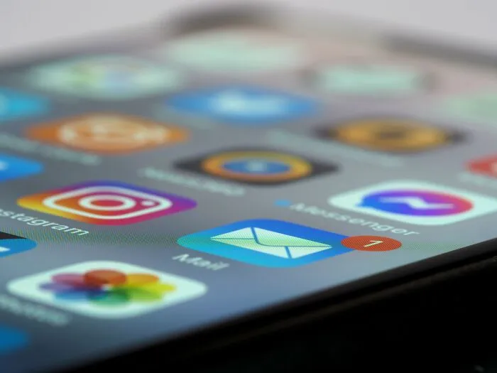 Close-up of smartphone displaying popular social media and email apps on screen