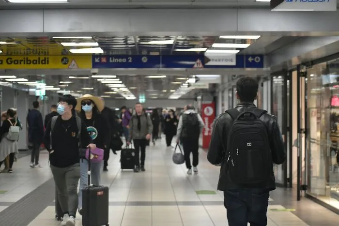 Busy airport corridor with travelers and luggage during vacation