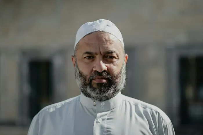 Pensive bearded man in traditional clothes family cut off reasons