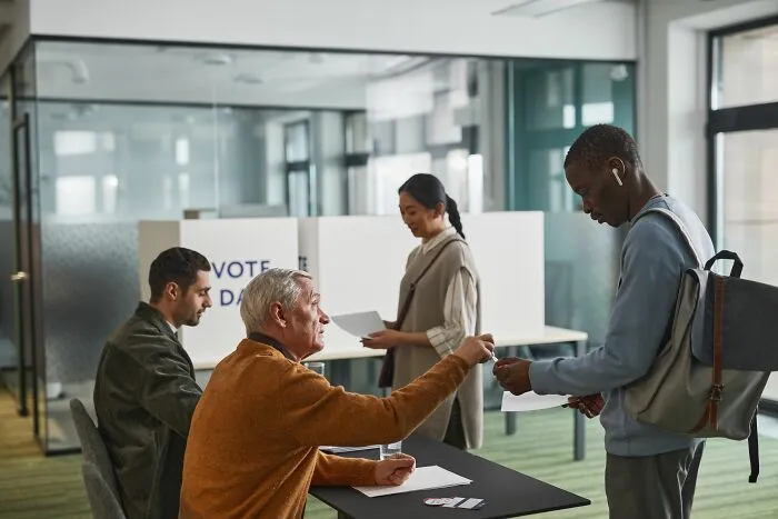 People interacting at a voting poll desk, highlighting social encounters with entitled parents.