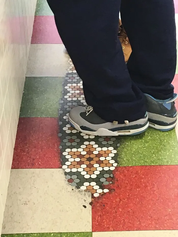Worn floor showing original mosaic tiles underneath, proving how time slowly reshapes floors