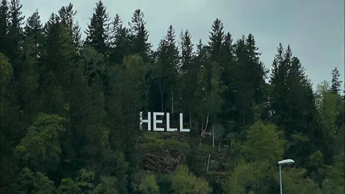 Large white letters spelling Hell on a forested hillside, showcasing unusual signs