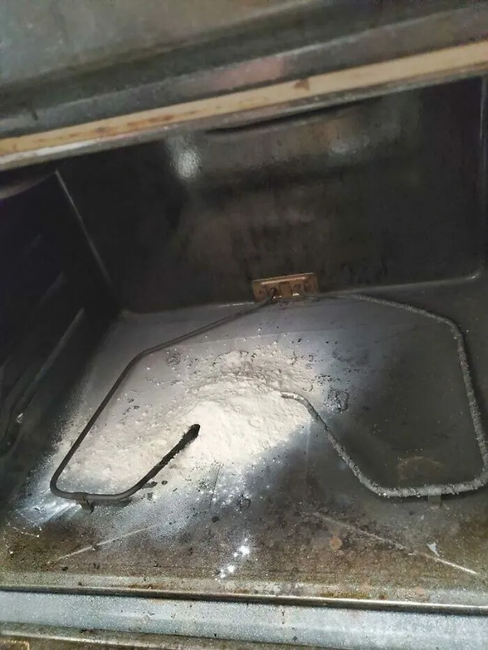 Interior of an oven with a burnt heating element and white residue, a significant kitchen fail.