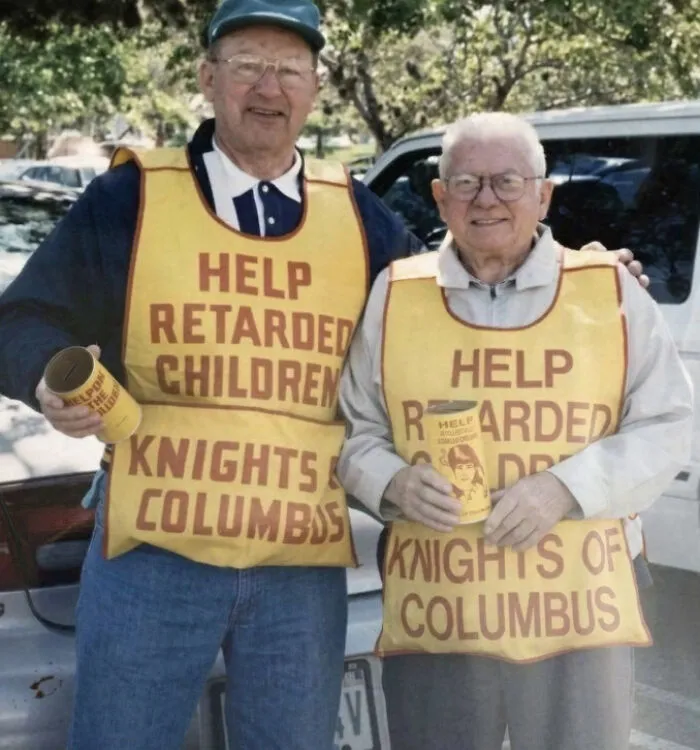 Two elderly men collecting donations for children with vintage vests