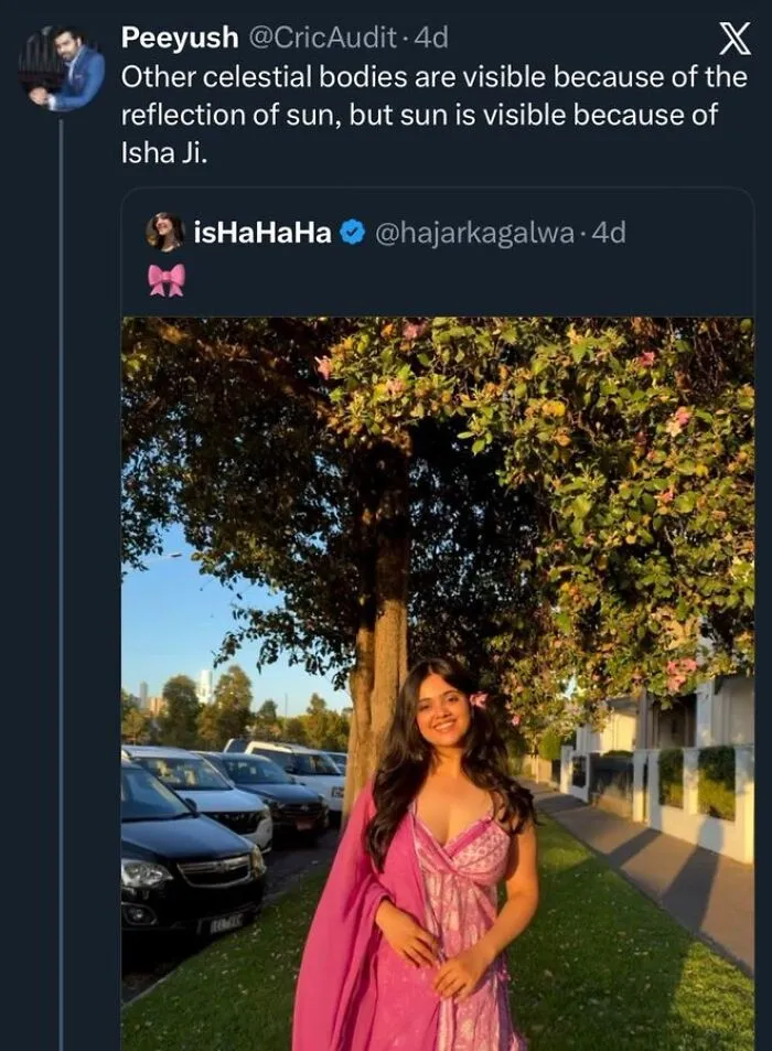 Woman in pink dress smiling under tree in golden hour light with starry-eyed lovers theme