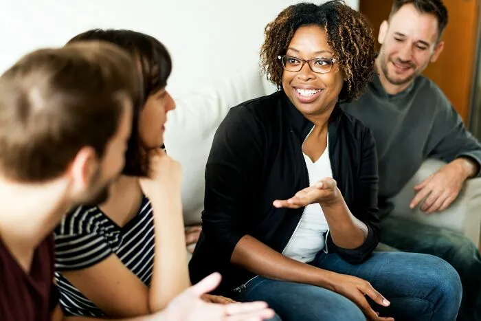 Group of diverse professionals talking together, sharing experiences of being unemployed.