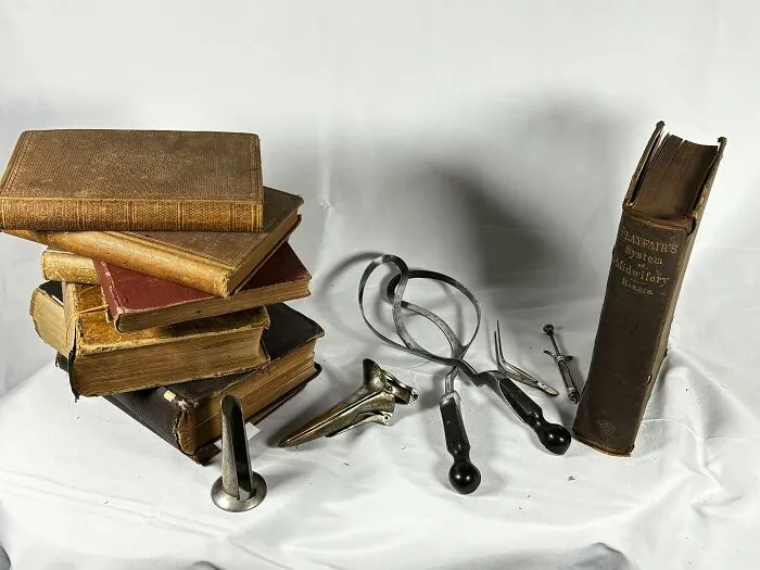 Old textbooks and forceps showing tools from medical history